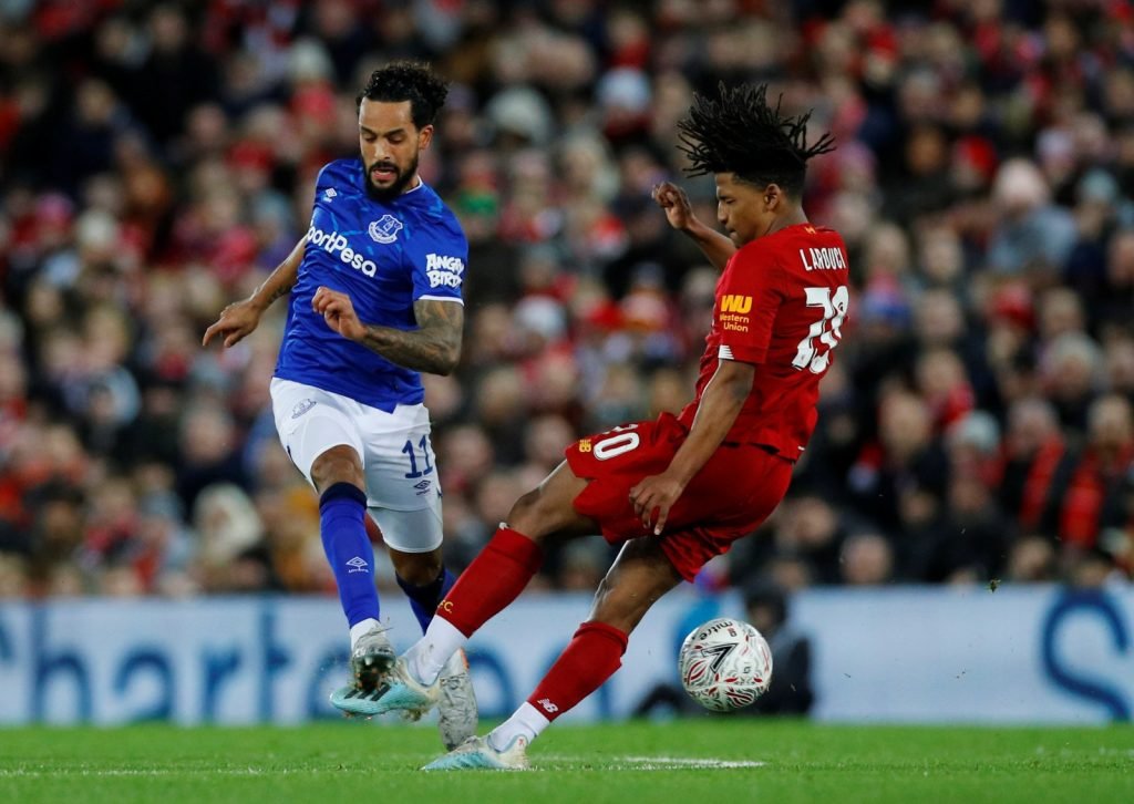 Everton's Theo Walcott in action with Liverpool's Yasser Larouci