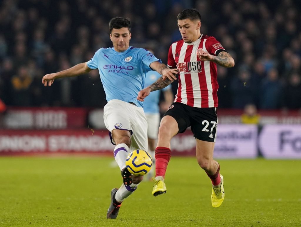 Manchester City's Rodri in action with Sheffield United's Muhamed Besic
