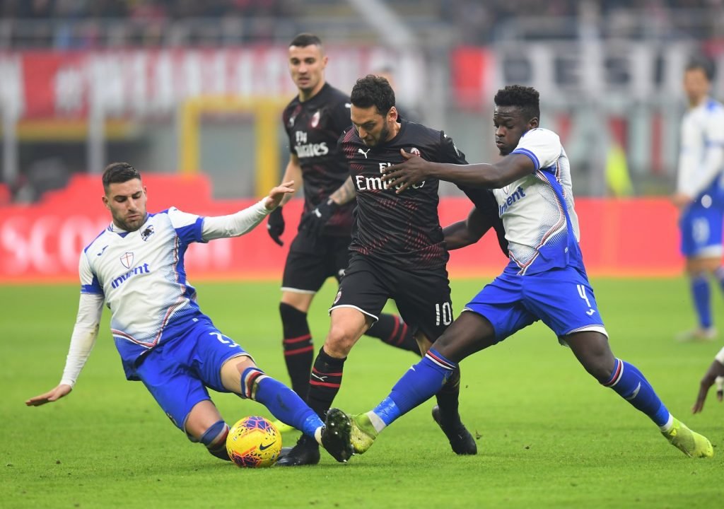 Sampdoria's Nicola Murru and Ronaldo Vieira in action with AC Milan's Hakan Calhanoglu