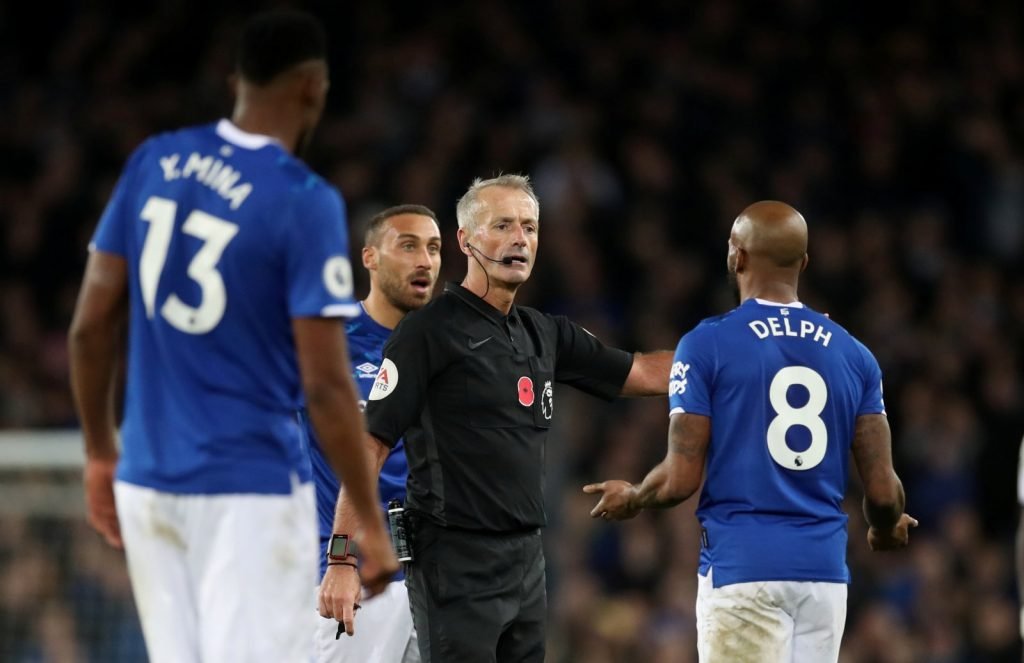 Everton's Fabian Delph talks to referee Martin Atkinson after he showed Tottenham Hotspur's Heung-min Son a red card for a challenge on Andre Gomes
