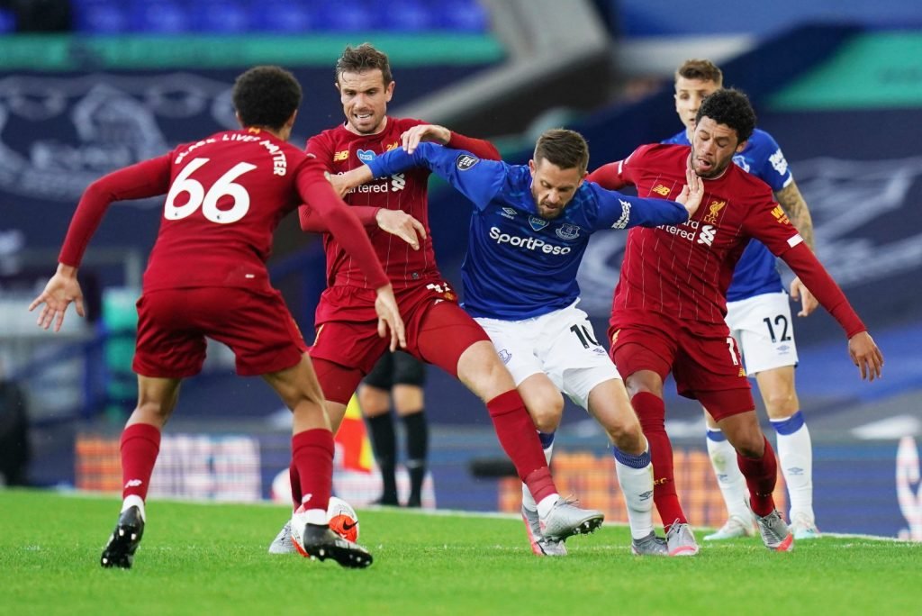 Gylfi Sigurdsson swarmed by Liverpool players in the derby