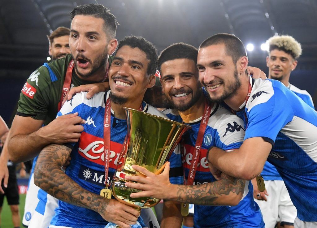 Napoli's Allan hugs the Coppa Italia trophy after their triumph