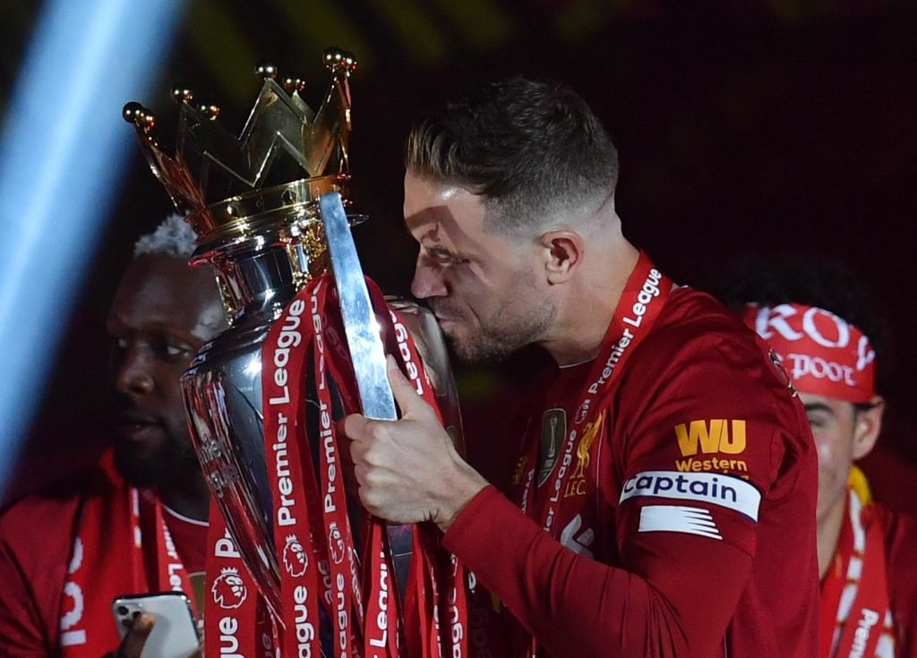 Liverpool's-Jordan-Henderson-with-the-trophy-after-winning-the-Premier-League