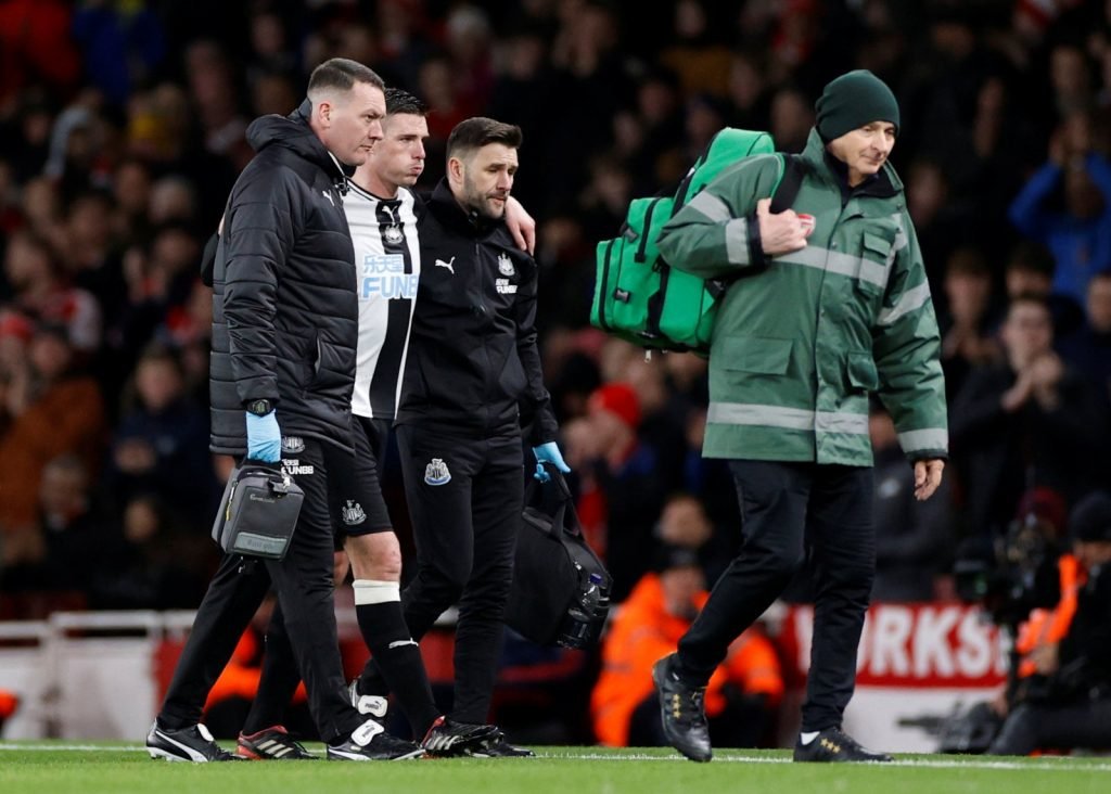 Newcastle United's Ciaran Clark is helped off the pitch by medical staff as he is substituted off after sustaining an injury vs Arsenal