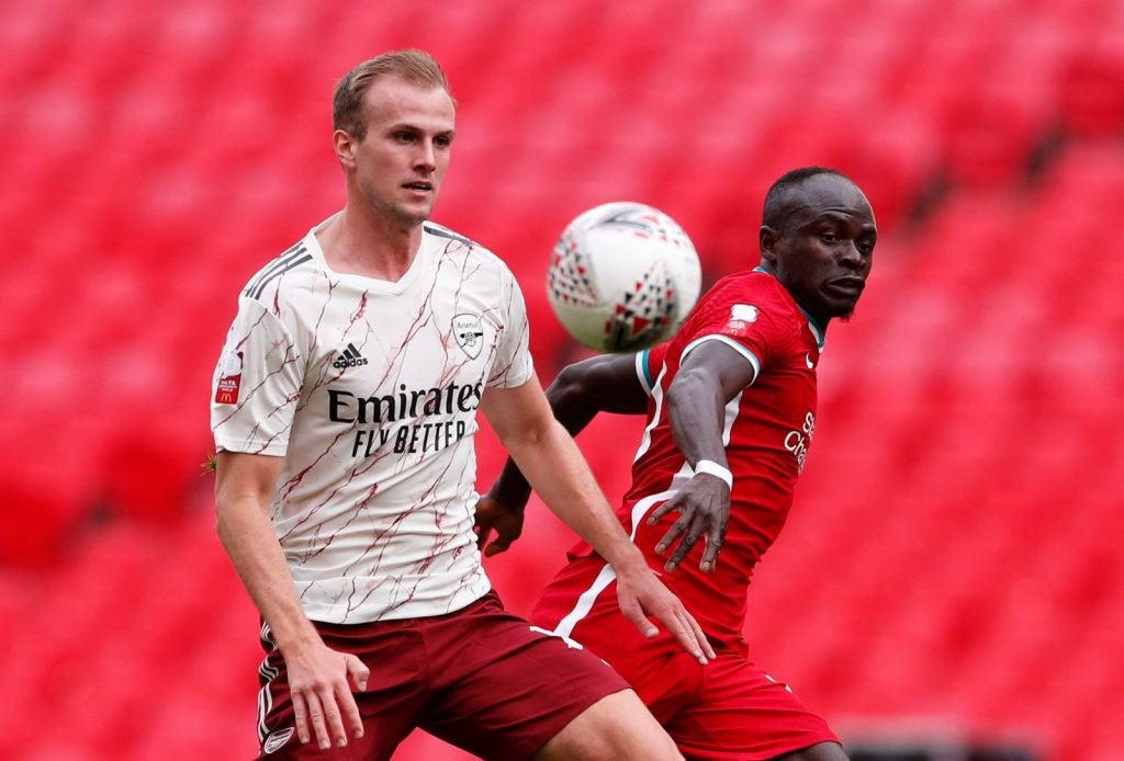 Arsenal's Rob Holding in action with Liverpool's Sadio Mane