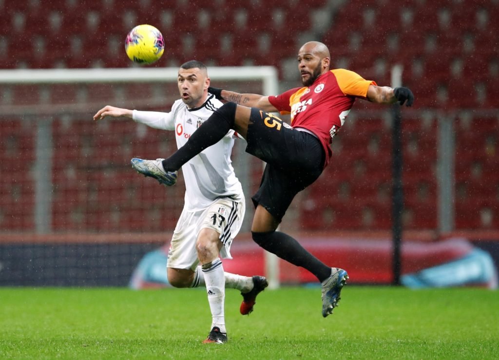 Galatasaray's Marcao in action with Besiktas' Burak Yilmaz