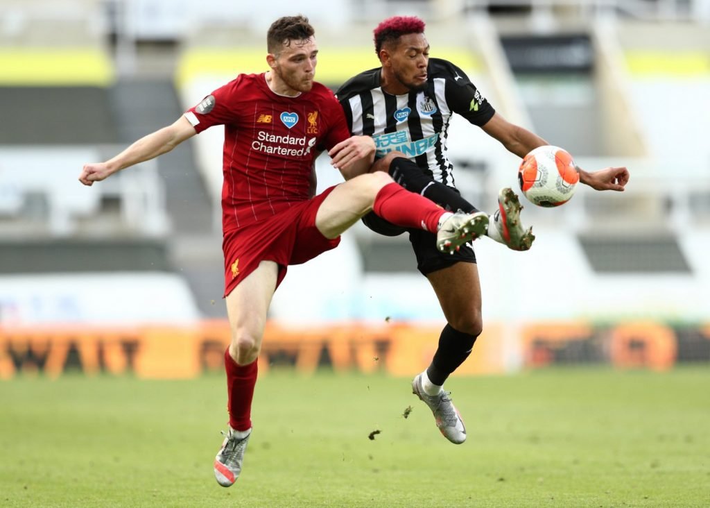 Liverpool's Andrew Robertson in action with Newcastle United's Joelinton