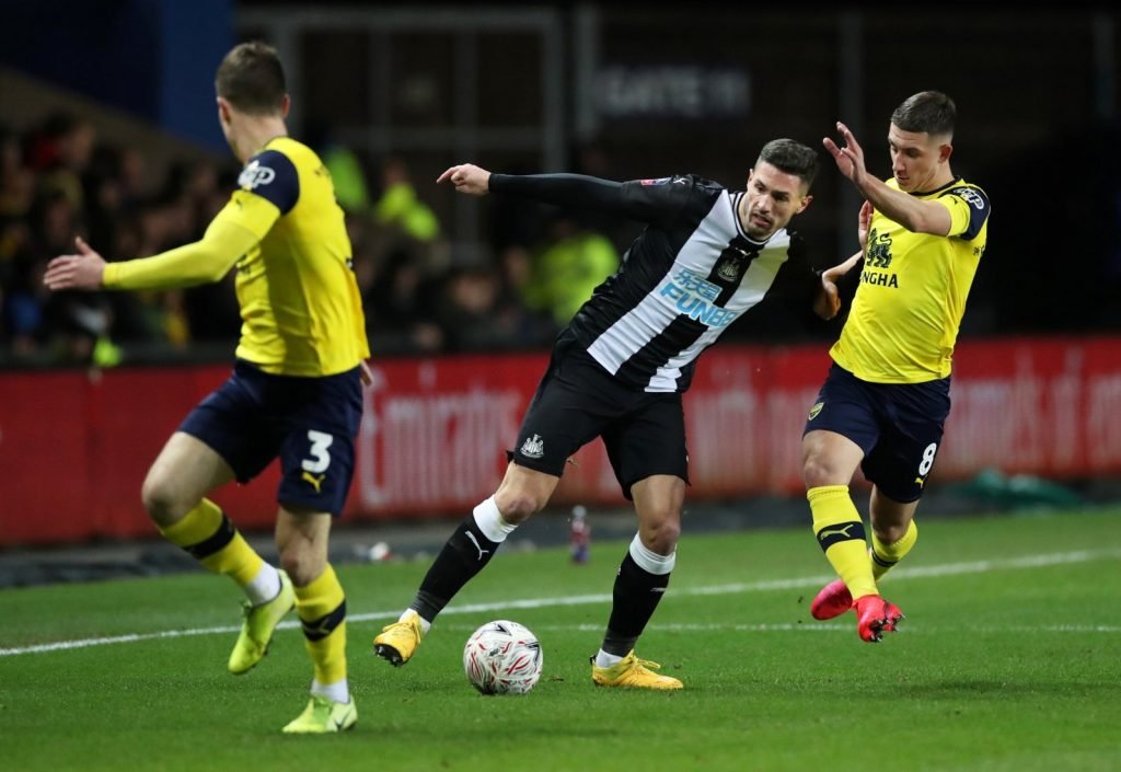 Newcastle United's Fabian Schar in action with Oxford United's Cameron Brannagan