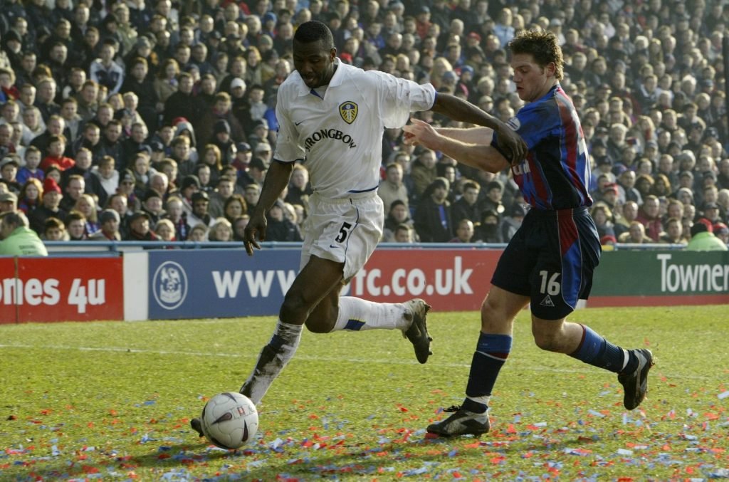 Leeds' Lucas Radebe is challenged by Palace's Tommy Black during FA Cup Fifth Round clash February 2003